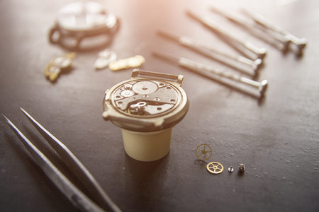 Watchmaker is repairing the mechanical watches in his workshopの写真素材