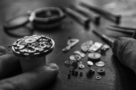 Watchmaker is repairing the mechanical watches in his workshopの写真素材