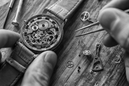 Watchmaker is repairing the mechanical watches in his workshopの写真素材