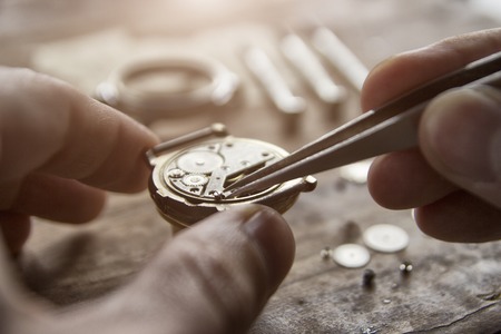 Watchmaker is repairing the mechanical watches in his workshopの写真素材