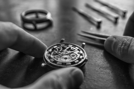 Watchmaker is repairing the mechanical watches in his workshopの写真素材