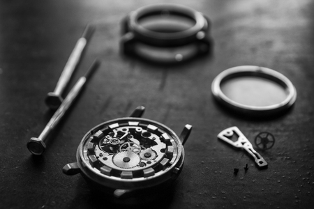 Watchmaker is repairing the mechanical watches in his workshopの写真素材