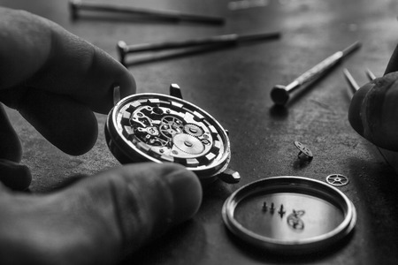 Watchmaker is repairing the mechanical watches in his workshopの写真素材