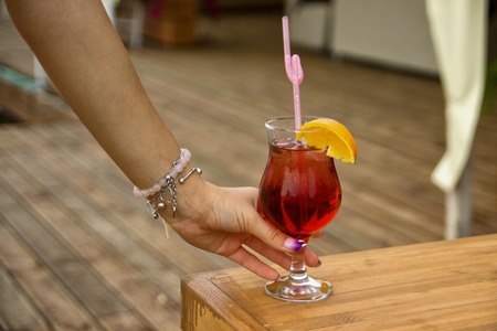 Woman's hand with a cocktail, red cocktailの写真素材