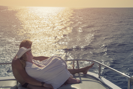 Two lovers are chilling out among the oceanの写真素材