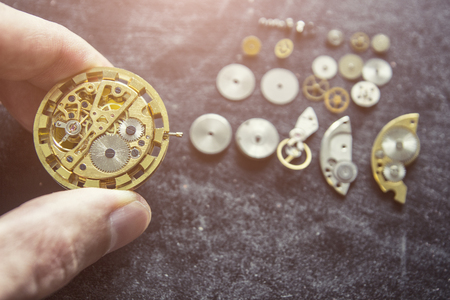 Watchmaker is repairing the mechanical watches in his workshopの写真素材