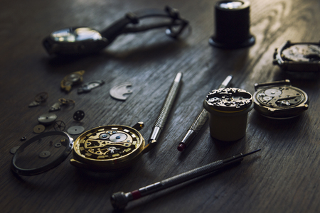 Watchmaker is repairing the mechanical watches in his workshopの写真素材