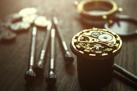 repairing the mechanical watches in his workshopの写真素材