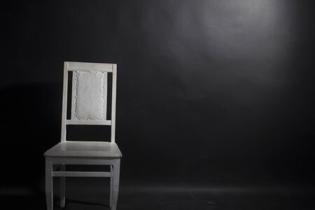 White chair on the black backgroundの写真素材