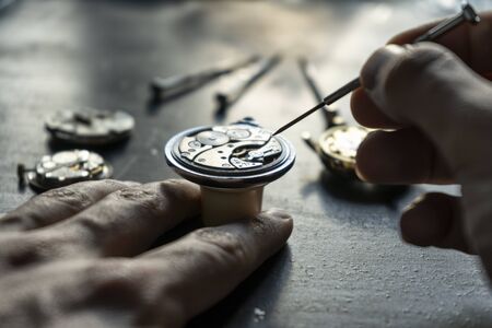 Watchmaker is repairing the wristwatch, mechanical watchの写真素材