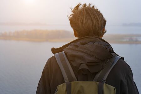 A man stands on a cliff, a sense of freedom