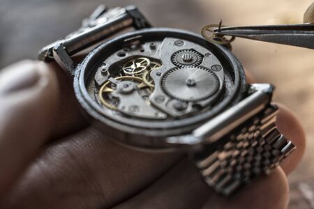 Watchmaker is repairing the wristwatch, mechanical watchの写真素材