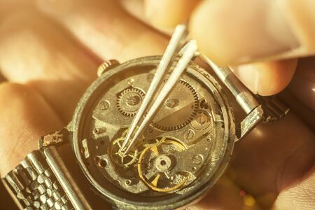 Watchmaker is repairing the wristwatch, mechanical watchの写真素材