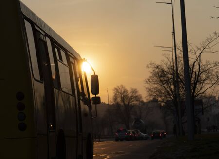 Bus on the empty street, sunsetの写真素材