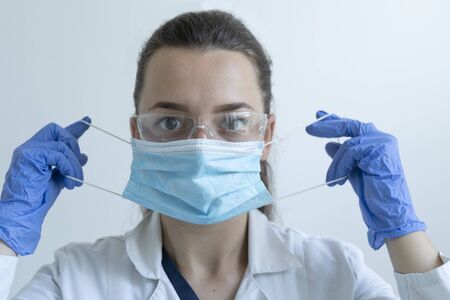 Doctor put on a protective maskの写真素材