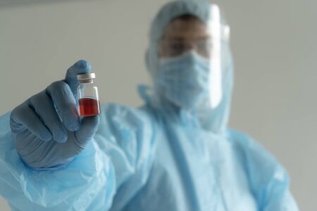 Doctor holds an ampoule with medicineの写真素材