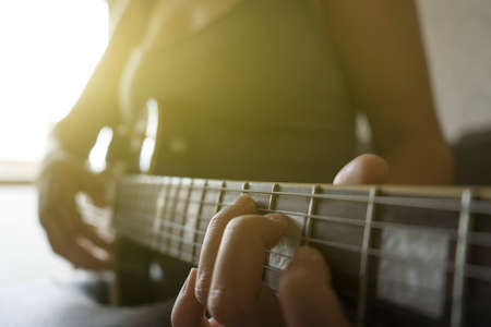 Girl learns to play the guitarの写真素材