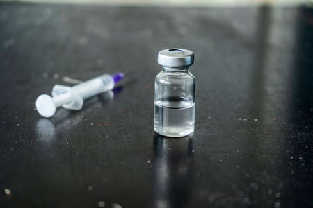 Syringe with ampoule on the table