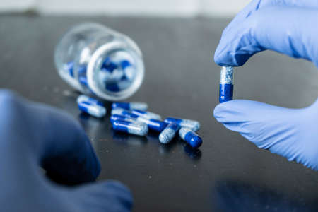 The doctor holds pills in his hands