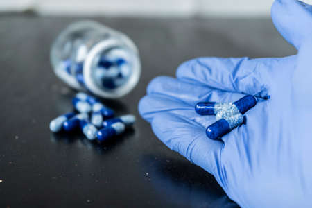 The doctor holds pills in his hands