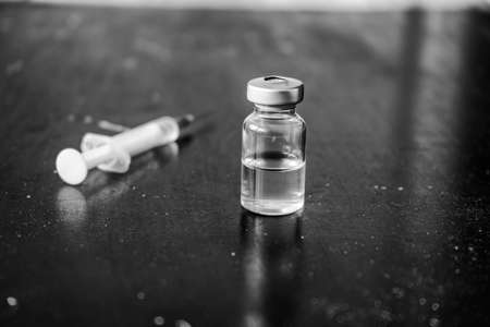 Doctor fills a syringe from an ampouleの写真素材