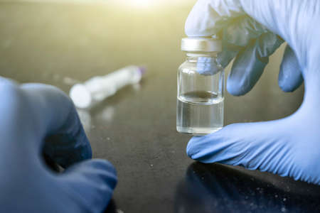 Doctor fills a syringe from an ampouleの写真素材