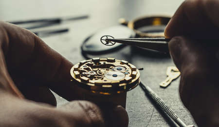 Watchmaker is repearing mechanical wrist watchの写真素材