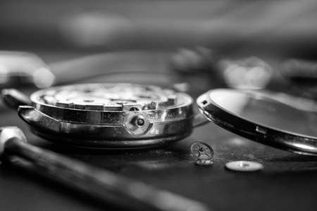 Mechanical watch assembly, watchmakers workshop with many parts and gears