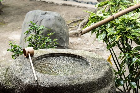 Water Spout and Stone at Bhuddist Temple in Kyoto, Japanの写真素材