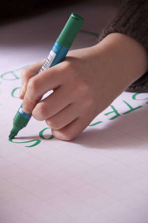 photo of a hand writing with a penの写真素材