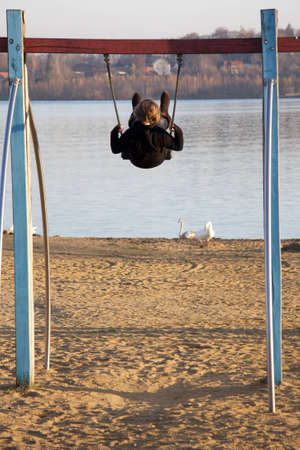 Girl on a swing backの写真素材