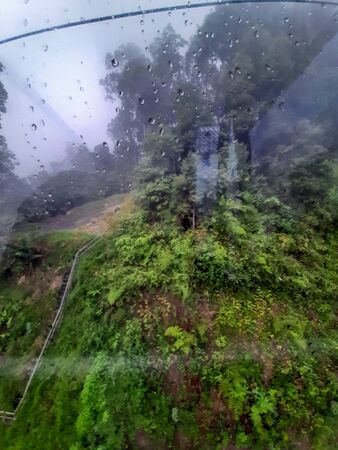 View of cable car to Genting highland with the water dropped on the glass in Kuala Lumpur Malaysiaの写真素材