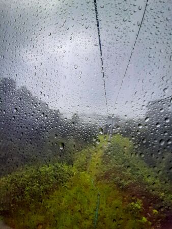 View of cable car to Genting highland with the water dropped on the glass in Kuala Lumpur Malaysiaの写真素材