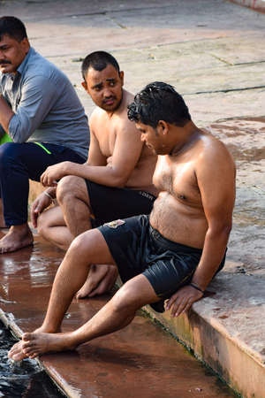 Delhi, India - Dec 31, 2019 : Man taking bath in holy river of Yamuna during morning time in Delhi India, People taking holy dip inside Yamuna riverのeditorial素材