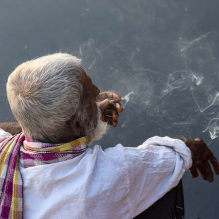 New Delhi, India - March 04, 2020: A man sitting with Indian traditions during morning time at Yamuna river ghat in New Deli, India, Yamuna Ghat Viewのeditorial素材