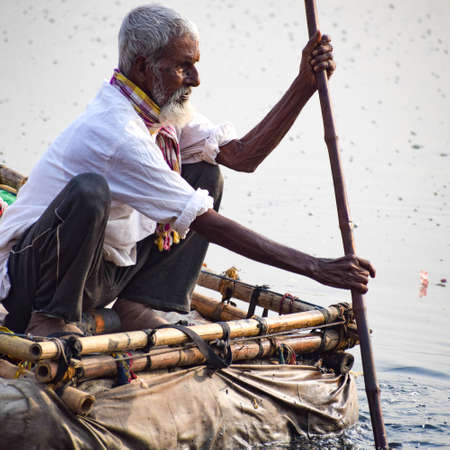 New Delhi, India - March 04, 2020: A man paddling a boat during morning time at Yamuna river ghat in New Deli, Indiaのeditorial素材
