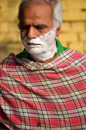 New Delhi, India - March 04, 2020: Handsome old man shaving his beard in bathroom during morning time at Yamuna river ghat in New Deli, India, Yamuna Ghat Viewのeditorial素材