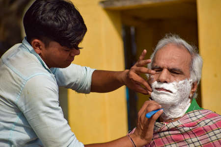 New Delhi, India - March 04, 2020: Handsome old man shaving his beard in bathroom during morning time at Yamuna river ghat in New Deli, India, Yamuna Ghat Viewのeditorial素材