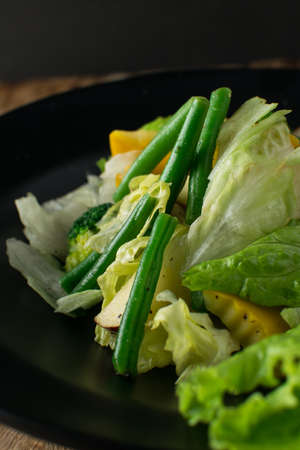 Penne pasta in tomato sauce with chicken, tomatoes decorated with parsley on a wooden table, Penne pasta with meatballs in tomato sauce and vegetables in bowl. Top view. Flat layの写真素材