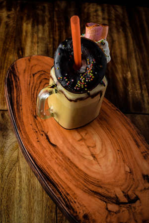 Big mug of hot cocoa with ice cream, whipped cream, chocolate chips and fluffy marshmallow, Cup of cold coffee, Coffee with Ice Cream, Coffee with Chocolate, Big Mug of Coffeeの写真素材