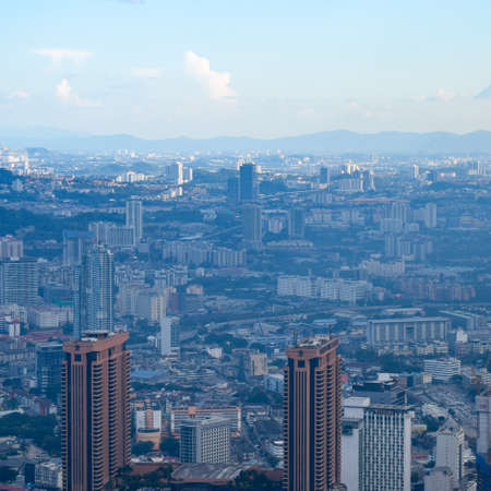 Cityscape of Kuala Lumpur with iconic buildings such as Petronas Twin Tower. Aerial view from KL...