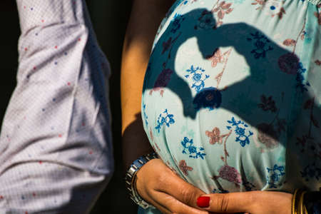 Maternity shoot pose for welcoming new born baby in Lodhi Road in Delhi India, Maternity photo shoot done by parents for welcoming their child during day time in Delhiの写真素材