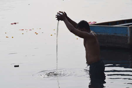 Delhi, India - Dec 31, 2019 : Man taking bath in holy river of Yamuna during morning time in Delhi India, People taking holy dip inside Yamuna riverのeditorial素材