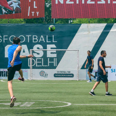 New Delhi, India - January 26 2020: Footballers of local football team during game in regional Derby championship on a bad football pitch. Hot moment of football match on grass green field of the stadiumのeditorial素材
