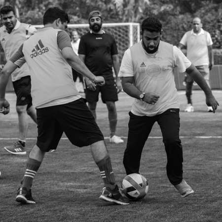 Delhi, India - July 19 2019: Footballers of local football team during game in regional Derby championship on a bad football pitch. Hot moment of football match on field of stadium â Black and Whiteのeditorial素材
