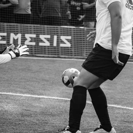 Delhi, India - July 01 2018: Footballers of local football team during game in regional Derby championship on a bad football pitch. Hot moment of football match on field of stadium â Black and Whiteのeditorial素材
