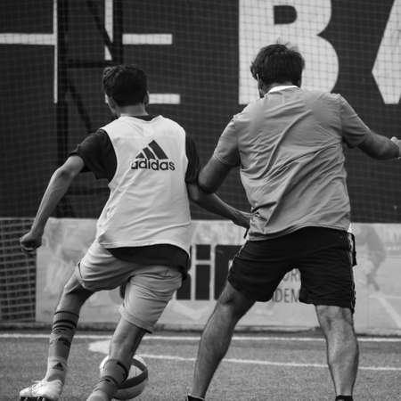 New Delhi, India - July 01 2018: Footballers of local football team during game in regional Derby championship on a bad football pitch. Hot moment of football match on grass green field of the stadiumのeditorial素材