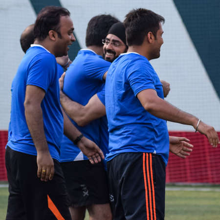 New Delhi, India - July 01 2018: Footballers of local football team during game in regional Derby championship on a bad football pitch. Hot moment of football match on grass green field of the stadiumのeditorial素材