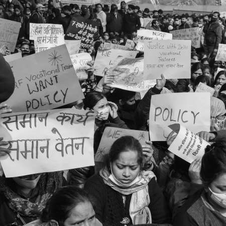 Delhi, India December 25 2021 : Delhi Contractual Guest Teachers with posters, flags and graffitiâs protesting against Delhi AAP Government for making policy, Delhi Teacher protesting Black and Whiteのeditorial素材