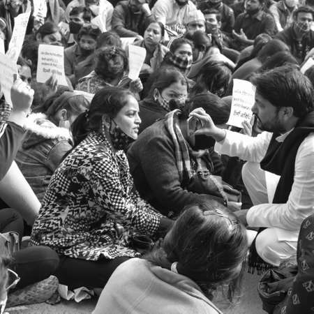 Delhi, India December 25 2021 : Delhi Contractual Guest Teachers with posters, flags and graffitiâs protesting against Delhi AAP Government for making policy, Delhi Teacher protesting Black and Whiteのeditorial素材